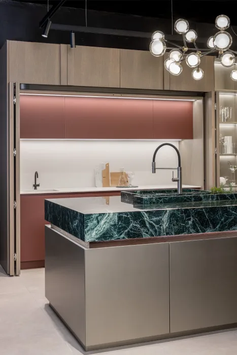 Pocket cabinet doors opening to reveal hidden storage in a luxury European kitchen