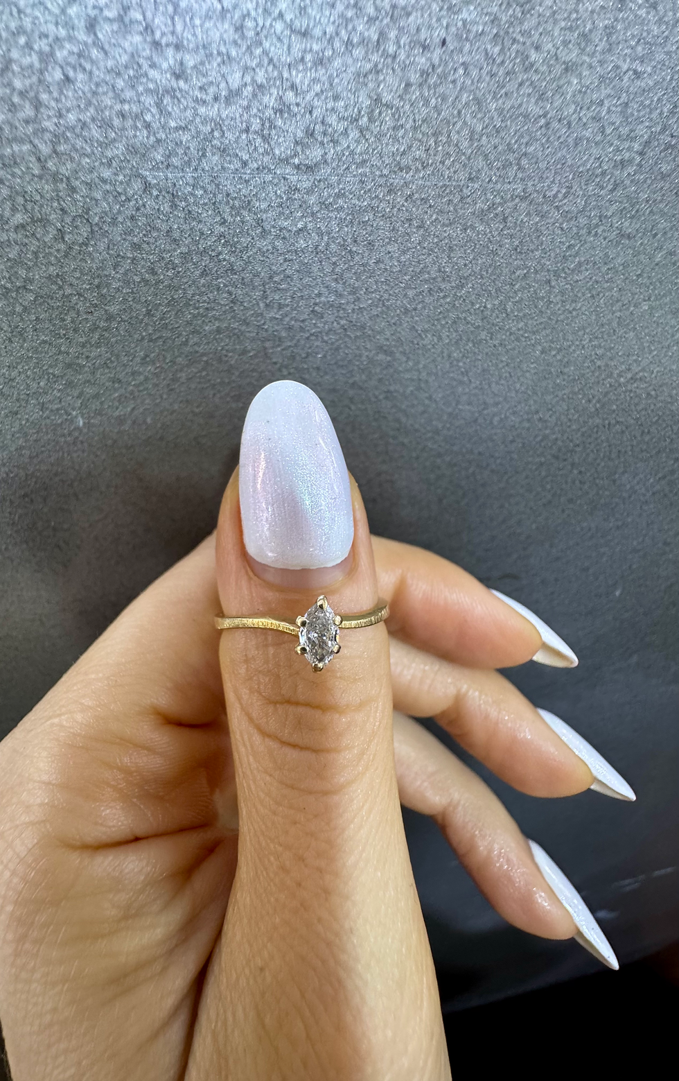 Thumbnail: Dainty 14kt Yellow Gold Marquise Shape Diamond Wavy Solitaire Ring