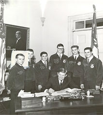 NC FFA state officers from the 1960s with a man at a desk