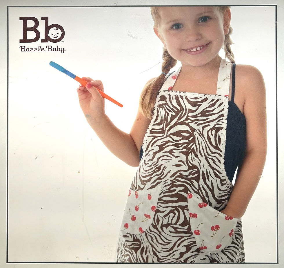 Daisy Davis modeling the Bazzle Baby Lil’ Helper Apron on an original catalog cover.