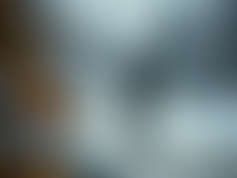 Golfer in winter attire tees off on a snowy course. Snowflakes fall, and blurred warm lights from a decorated tree glow in the foreground.