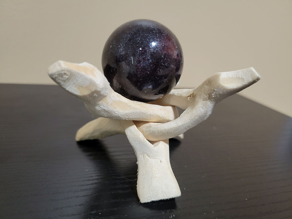 Small Lepidolite Sphere displayed atop of the wood holder.