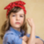 Little girl showing her muscle like rosie riviter