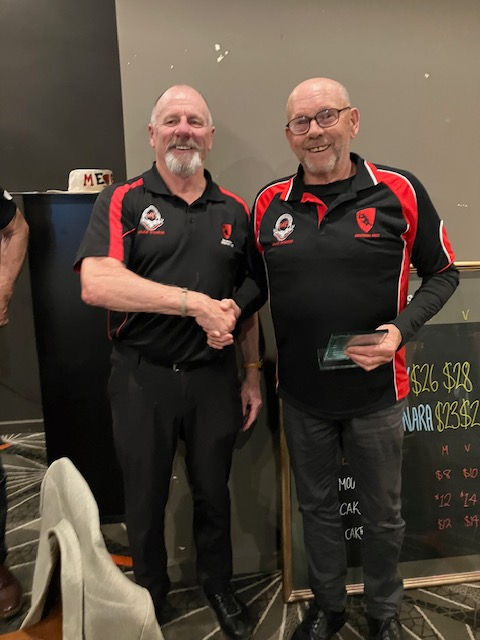 Mocca Boyse getting the over 60s MVP award from last years winner Michael Goldsmith
