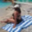 women sitting on navy blue and white striped towel at beach