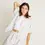 Thumbnail: women with short sleeve organic cotton pajamer top with pocket and high waisted shorts