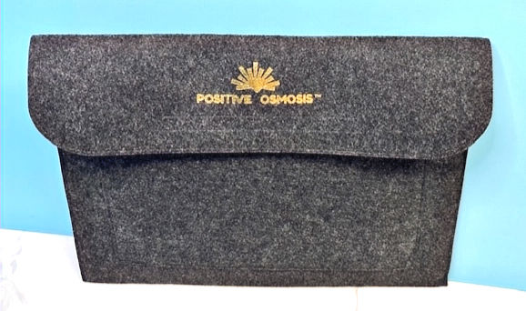 Gray Positive Osmosis bag on blue background with Positive Osmosis text.