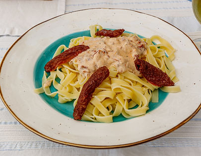 Tagliatelle pasta served with creamy sauce and sun-dried tomatoes.