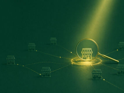 Magnifying glass highlighting a selected local business among connected businesses, representing AI-driven local search and digital visibility for small businesses in Puerto Rico.