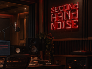 Recording studio interior featuring a custom illuminated wall sign for a modern music production studio brand identity.