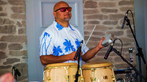 Tropicalia's percussionist in action on stage performing at corporate event