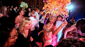Tropicalia samba dancer leading lively crowd interaction at wedding