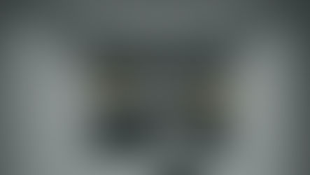 Signs of anxiety blog banner showing a person sitting alone in a quiet, dimly lit hallway