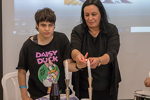 Therapist and Teen lighting Shabbat Candles