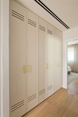 Neutral-toned built-in wardrobe by Natalie Sher Interiors