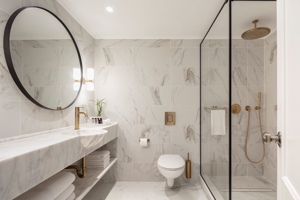 Modern bathroom with marble accents and gold fixtures