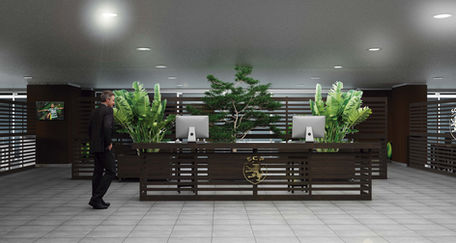 Homem caminhando em recepção moderna com balcão e plantas.