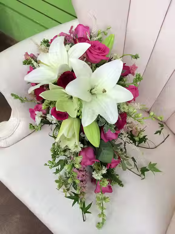 Price: $185.00
This hot pink and white mixed bouquet contains larkspur, roses, and lilies with an accent of ivy.