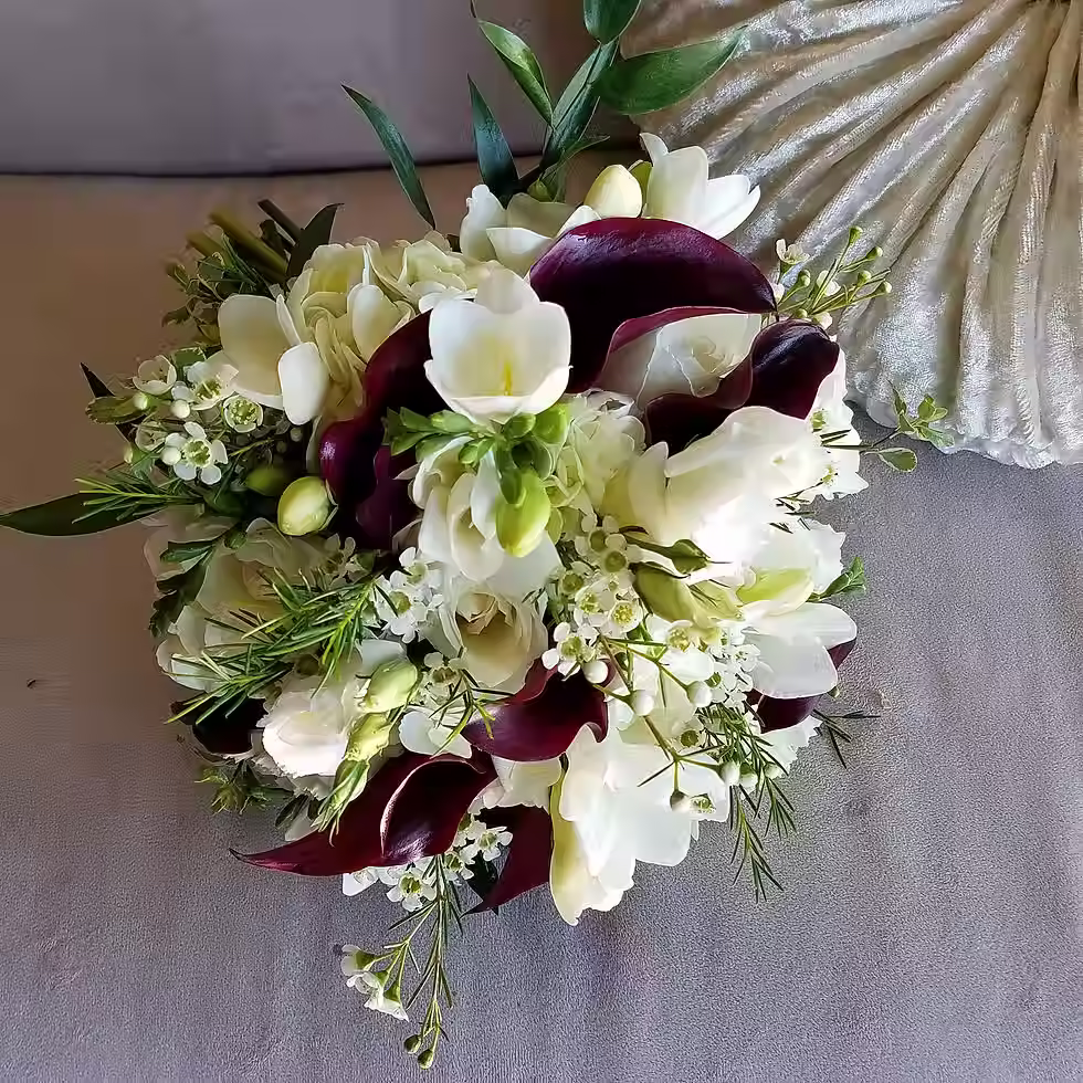 Price: $200.00
This bouquet uses a combination of waxflower, freesia, eggplant calla lillies, hydrangea, and spray roses.