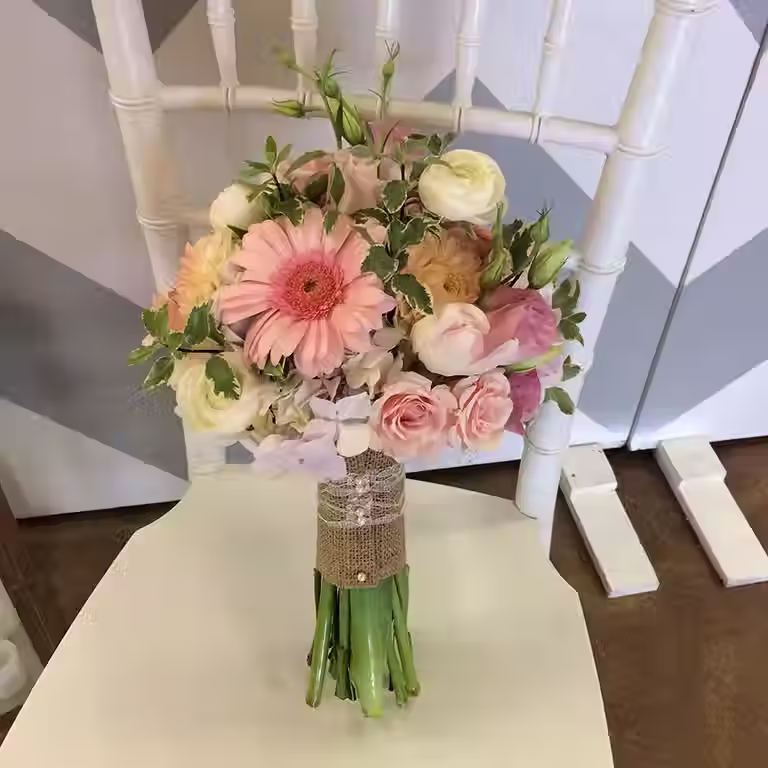 Price: $175.00
This bouquet combines gerbera daisies, ranunculus, lisianthus, spray roses, hydrangea, and krinkle pitt for a look reminiscent of spring gardens.