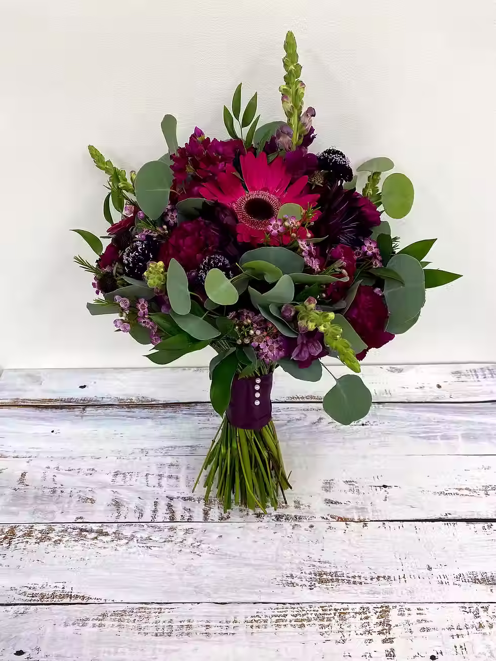 Price: $225.00
Dahlias, gerbera daisies, snapdragons, stock, scabiosa, carnations, and waxflowers with silver dollar eucalyptus.