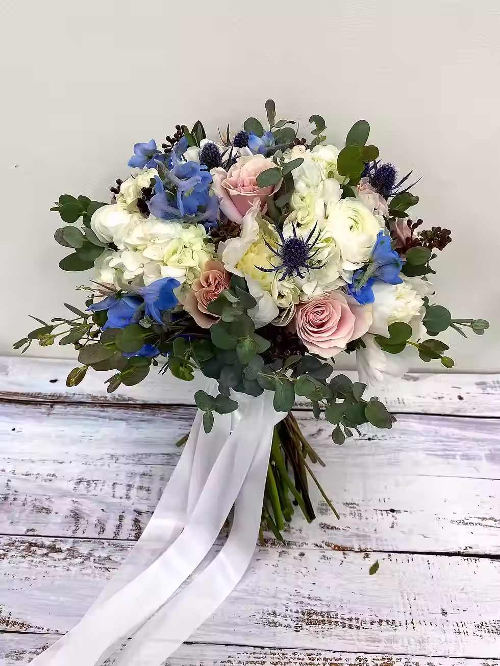 Price: With peonies $325.00, without peonies $225.00
Hydrangea, peonies (seasonal), ranunculus, roses, delphinium, eryngium, and eucalyptus.