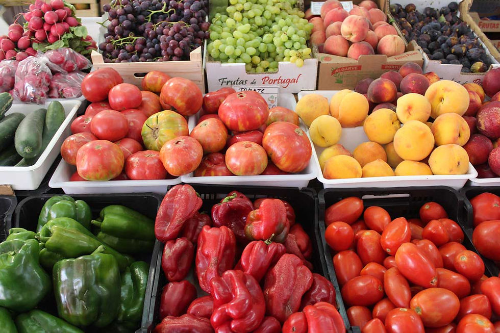 Fruit market in Algarve selling locally grown peppers, tomatoes, peaches and grapes