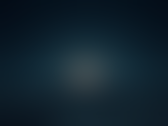 Wide angle view of a desert landscape under a starry night sky with a glowing red moon near the horizon