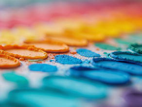 Close-up view of a vibrant watercolor palette showcasing different hues