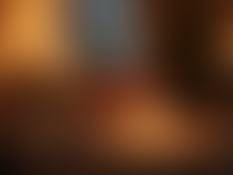 Eye-level view of a cozy living room set up for a romantic dinner at home with candles and soft lighting