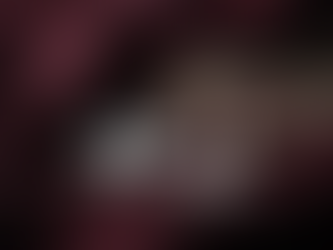 Close-up view of silver and gold winter jewelry pieces on a dark velvet background