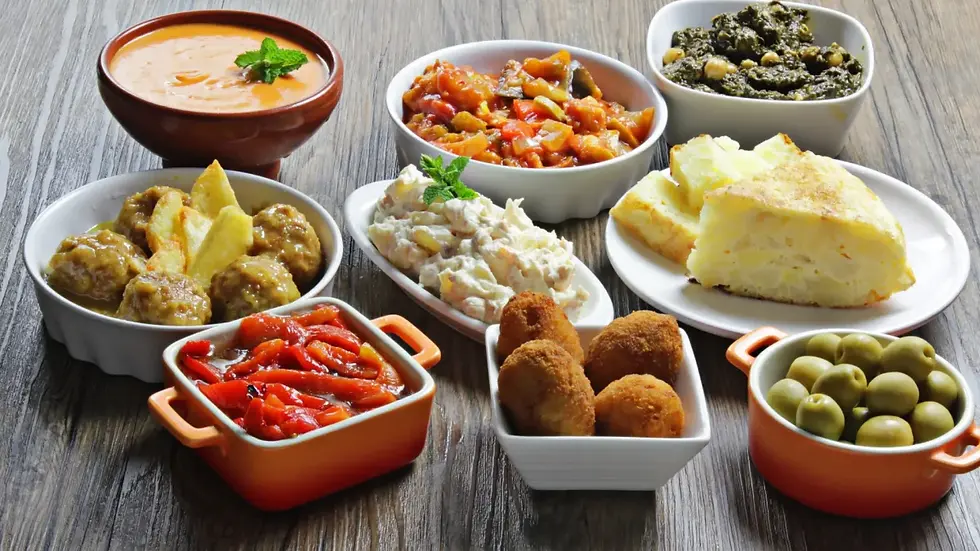 High angle view of a traditional Seville tapas spread with various dishes and drinks