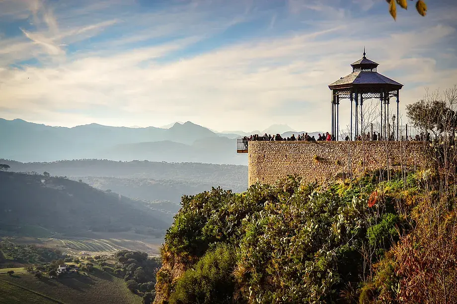 High angle view of the deep gorge and Puente Nuevo bridge from Jardines de Cuenca