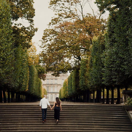 Engagement film photo of a couple in Tuileries Garden, sharing a romantic moment captured on timeless film