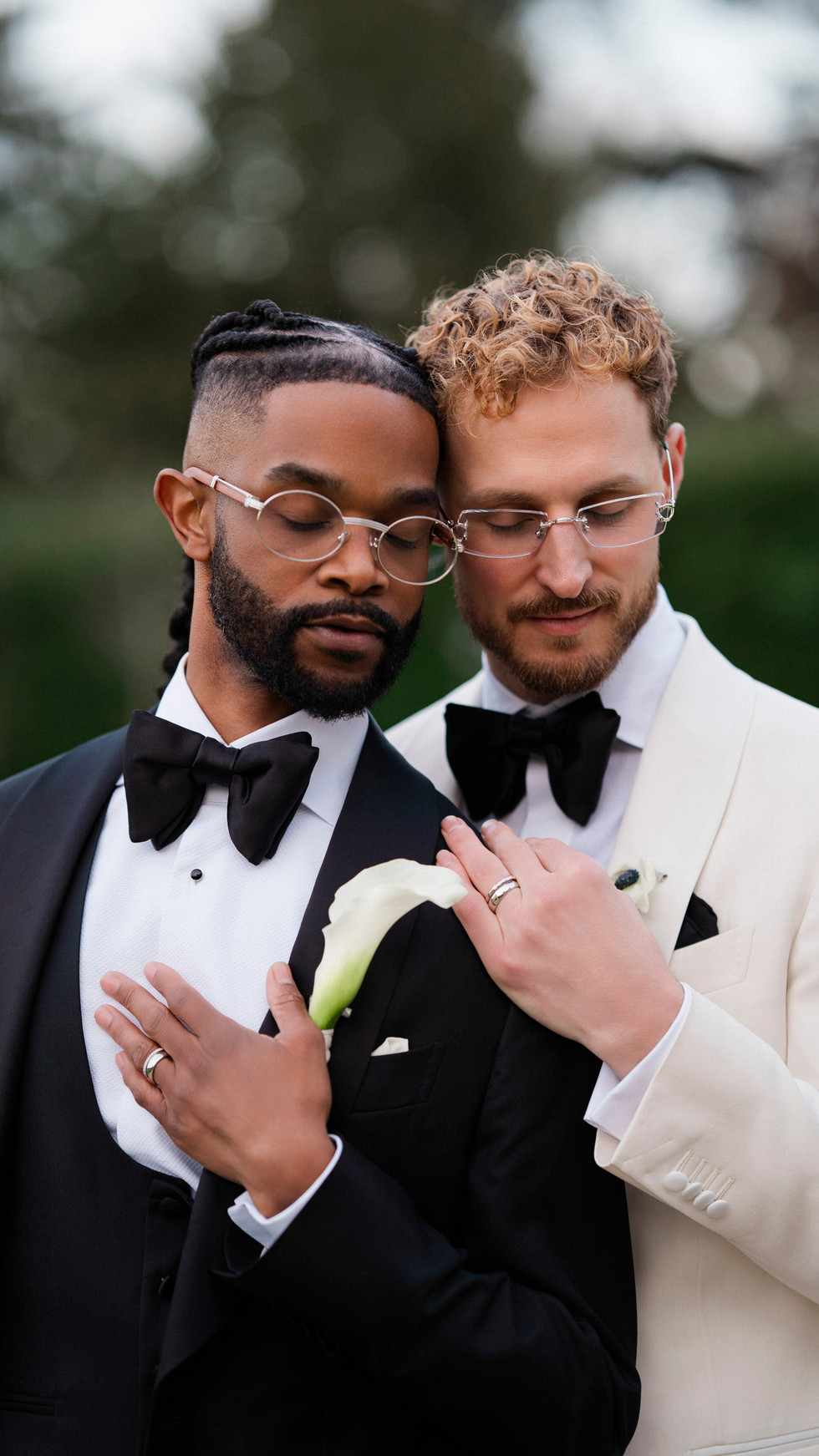 Intimate wedding moment framed by château and manicured gardens