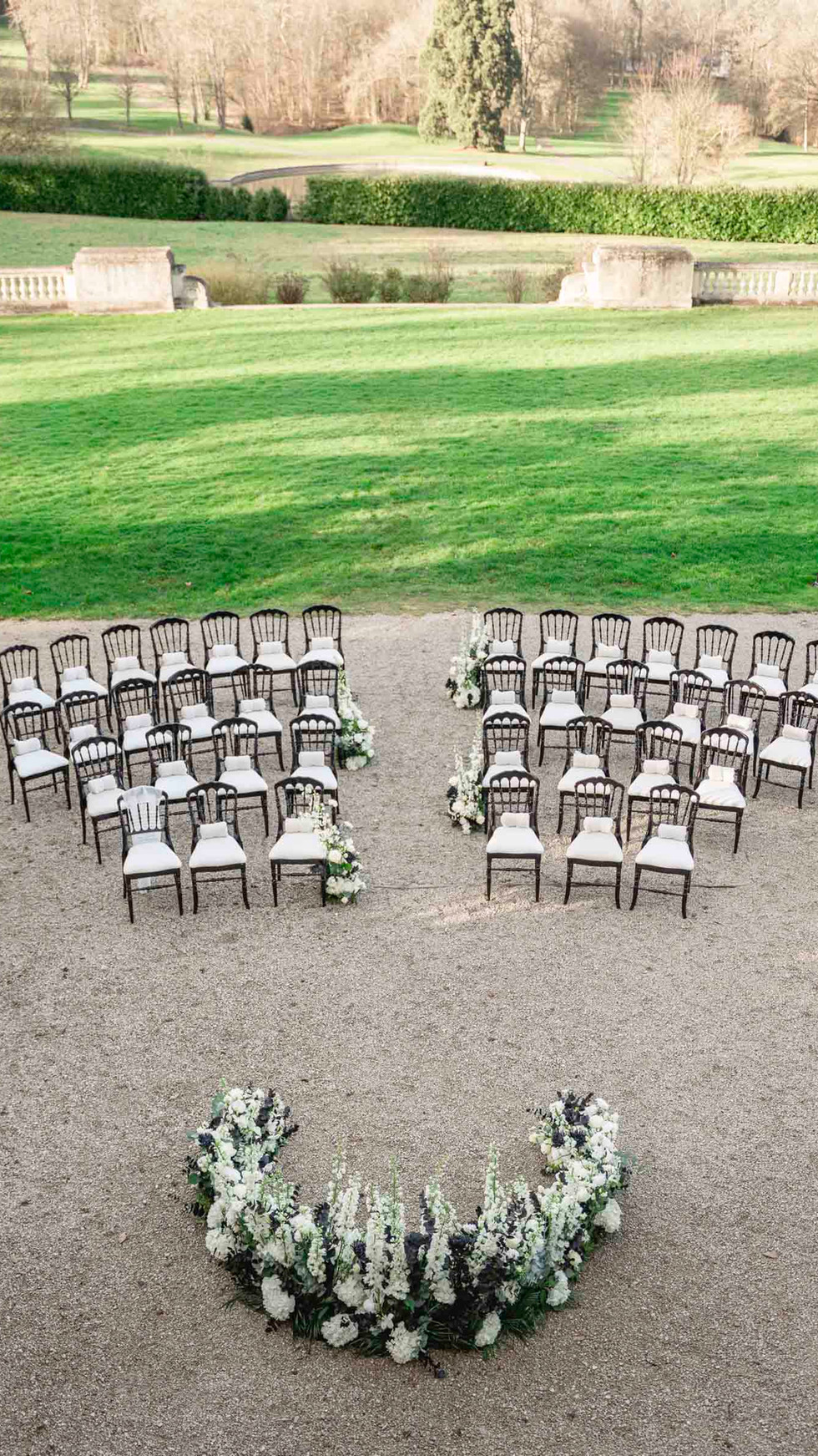 Outdoor wedding scene with elegant French château setting