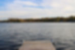 The Fun at the Lake dock rests on the water at sunset.