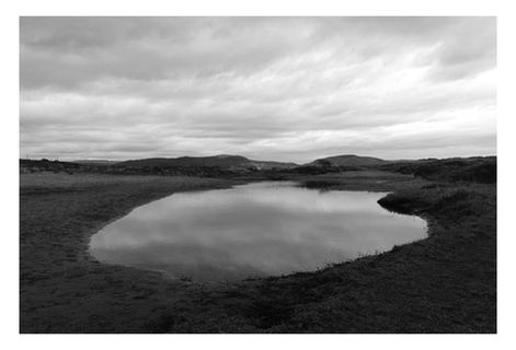 Black and white photograph at Crymlyn Burrows, South Wales.  A pool amongst dunes photographed in low winter light.