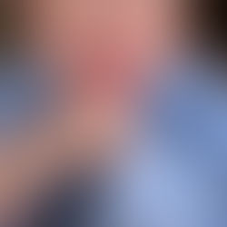 Sarah-Jane Outten is looking to camera wearing a red lipstick.