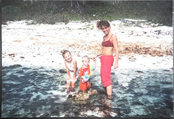 happy kids and mom on a beach