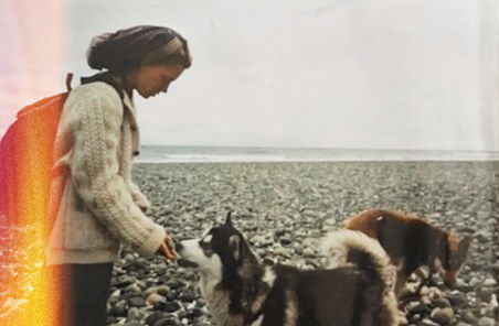 mom rewilding with wolves on a beach