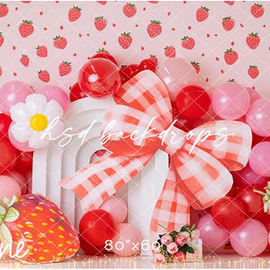 Strawberry-themed birthday backdrop with red and pink balloons, gingham bow, daisies, and strawberry props – ideal for cake smash and first birthday photography