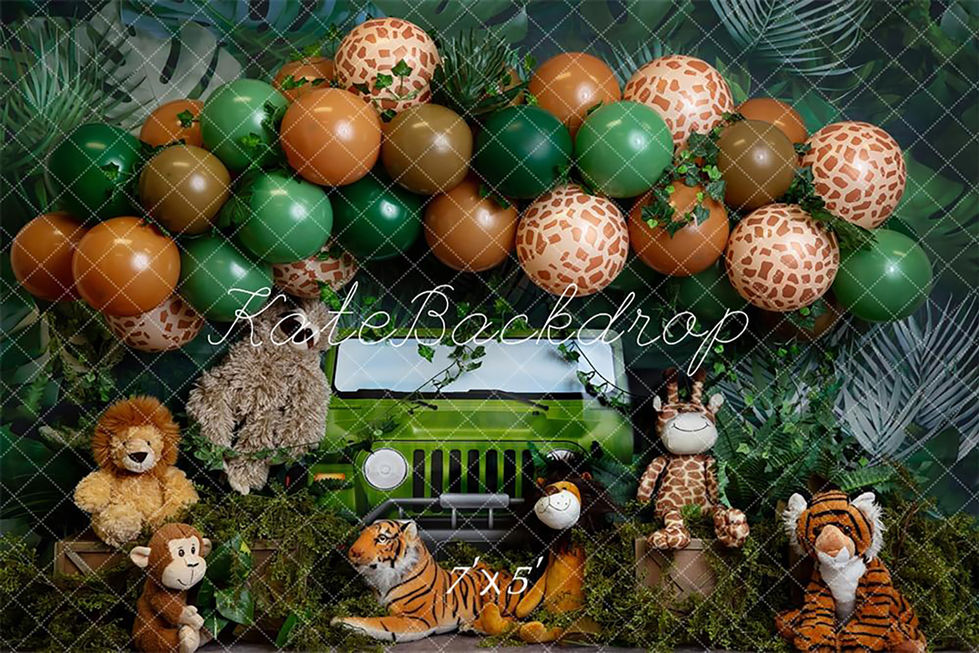 Jungle safari-themed backdrop with Jeep, balloon garland, and plush animals at Shutter Swan Studios in Lakeland, FL for wild one and jungle-themed photo shoots