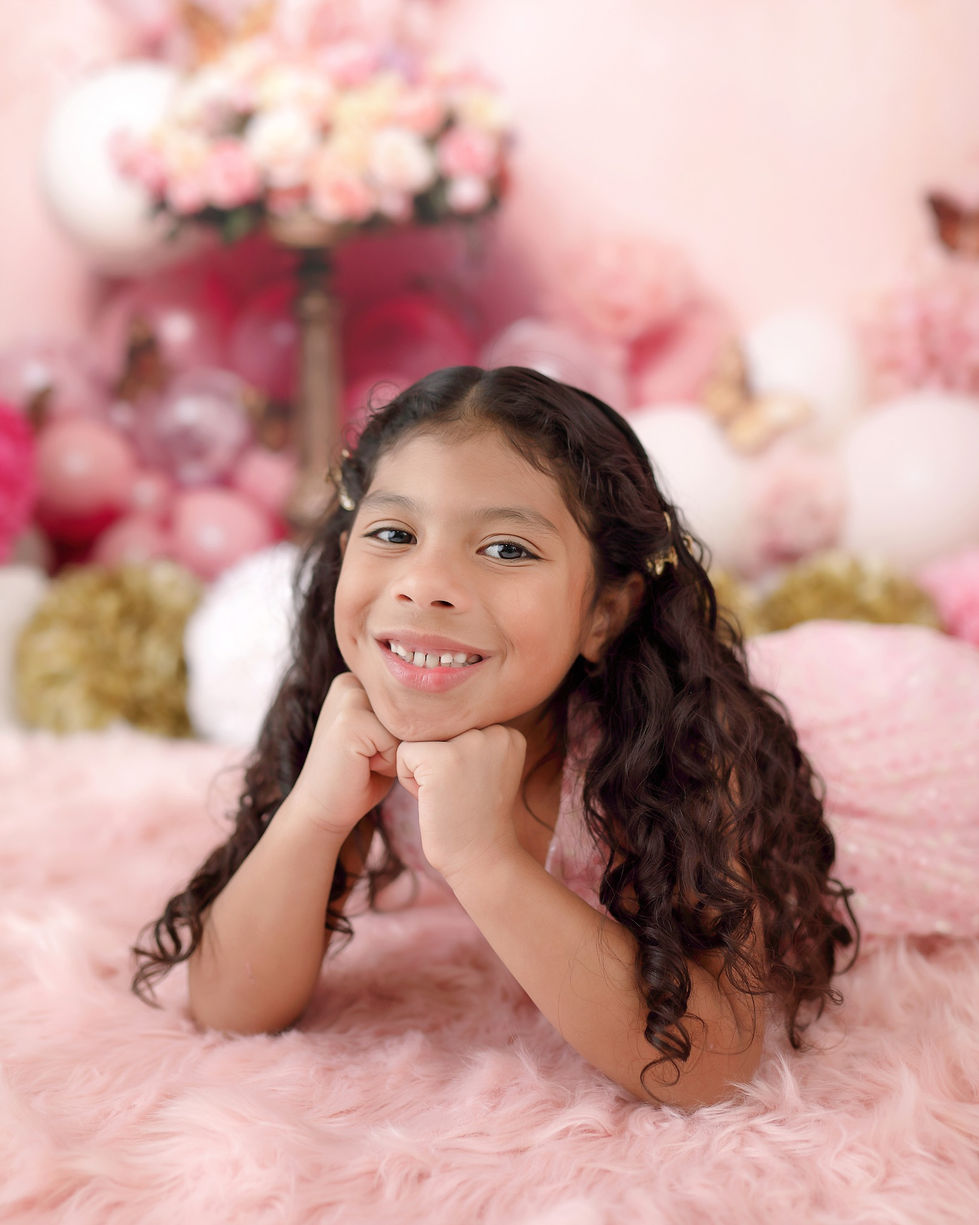 Rose gold and pink butterfly-themed cake smash backdrop with balloons, soft florals, and vintage decor – ideal for first birthday and milestone photography