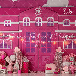 Barbie-themed birthday backdrop with pink Barbie mansion, heart lights, glam accessories, and floral props for a fun and girly cake smash photo session