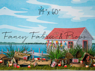 Fishing-themed photography backdrop with dockside shack, red roof, colorful buoys, bobbers, and crates at Shutter Swan Studios in Lakeland, FL – great for outdoor adventure photo sessions
