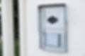 white intercom with a camera on the door