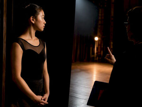 Performer receiving a backstage cue