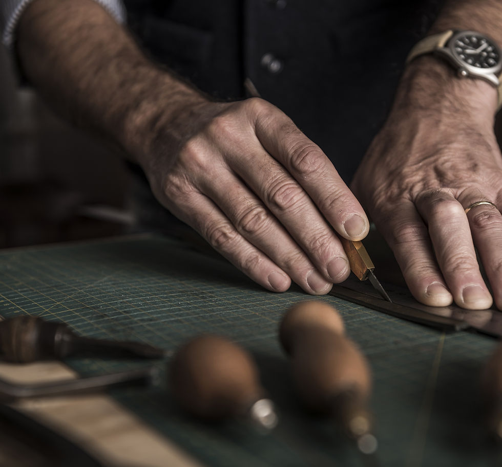 A GFS master saddler crafting leather.