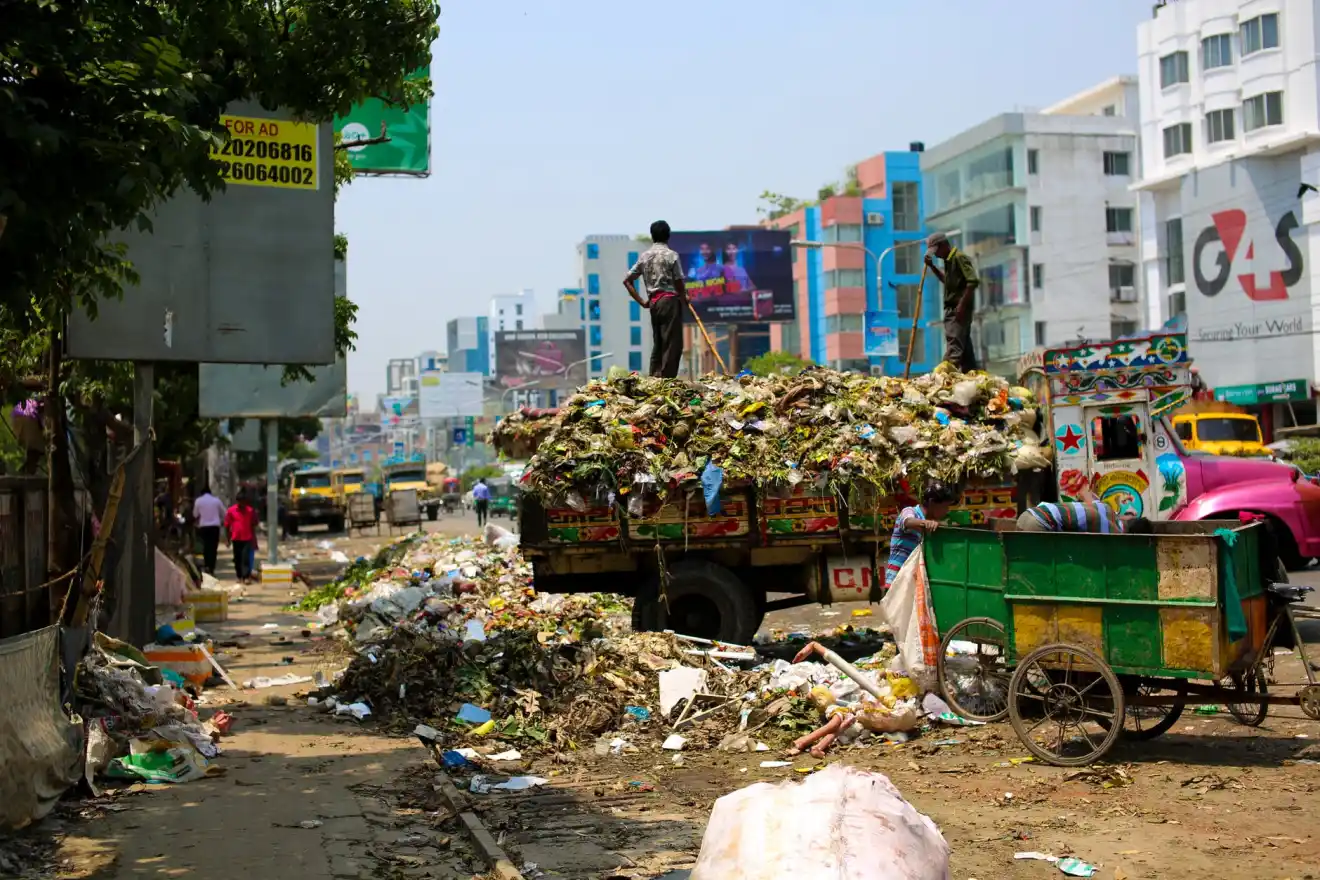 Stop Food Waste - photo of a dump truck across buildings